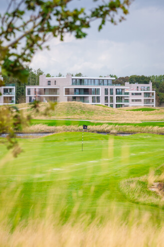 golf terrein met appartement op achtergrond